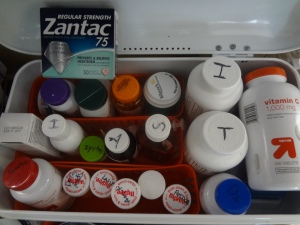 A white box filed with 20 different pill bottles and boxes